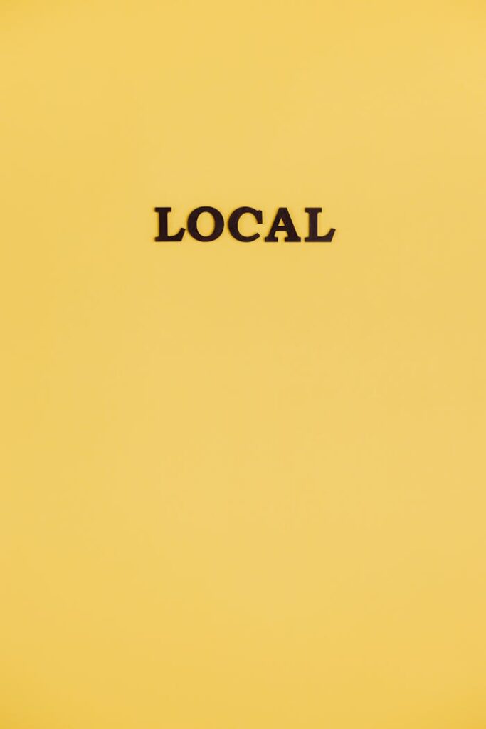A simple yellow background with the word 'local' centered, offering ample copy space.