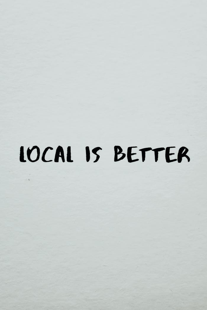 Simple typography poster with the slogan 'Local is Better' emphasizing local business support.